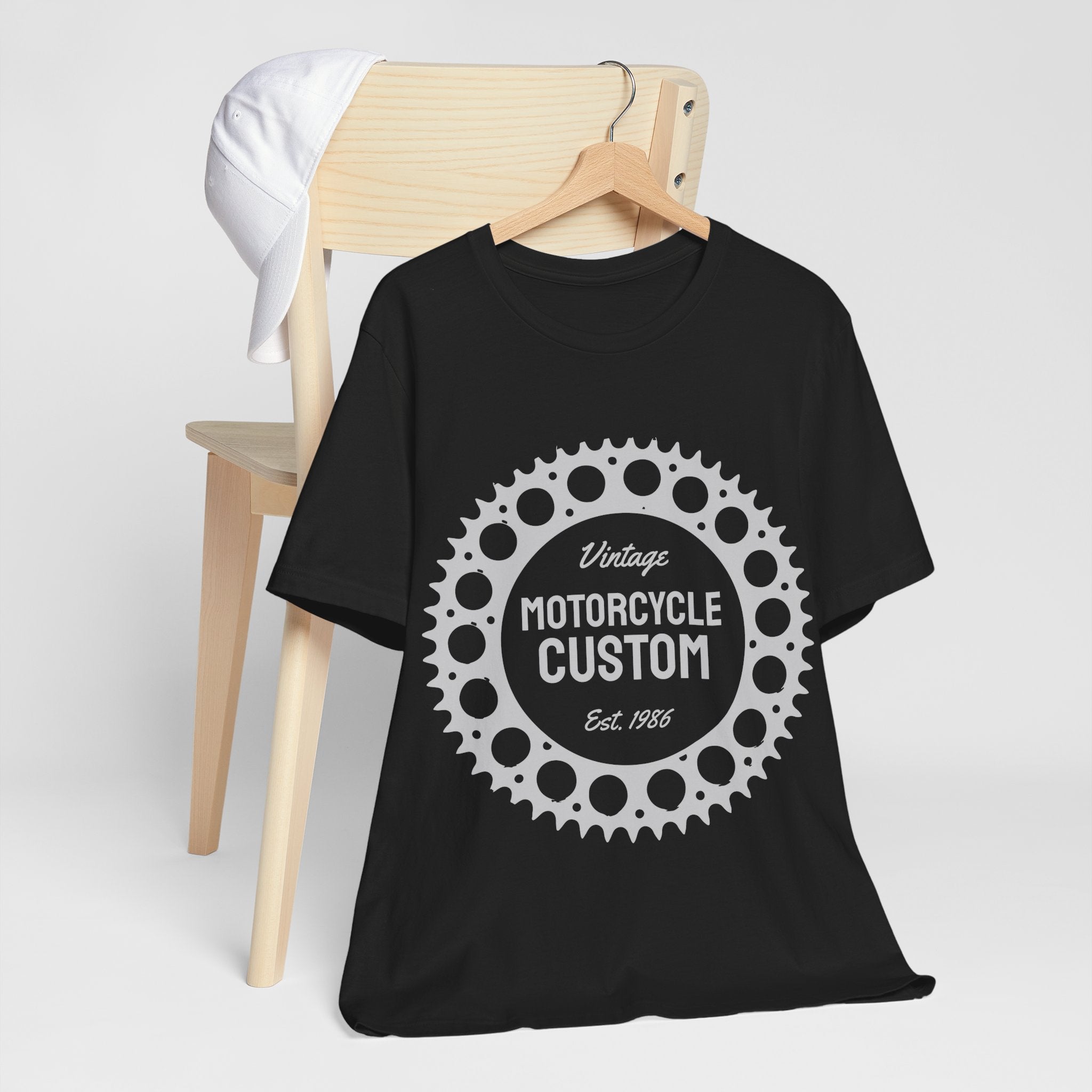 Black t-shirt with 'Vintage Motorcycle Custom' design on a wooden chair.