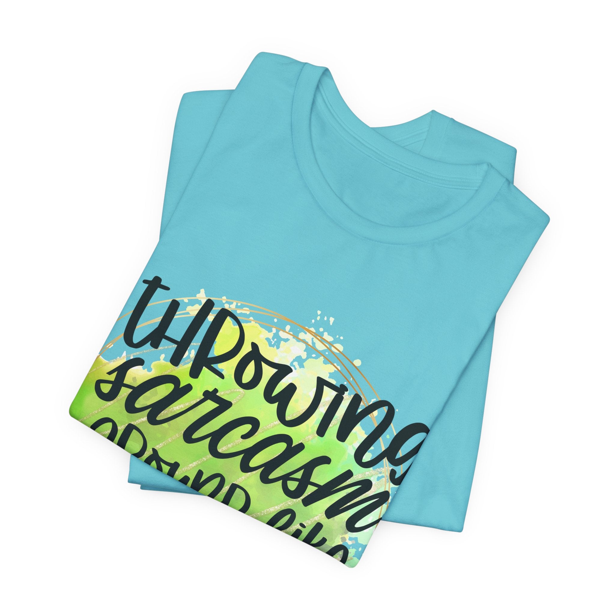 Folded Light blue t-shirt with colorful graphic and text on a white background