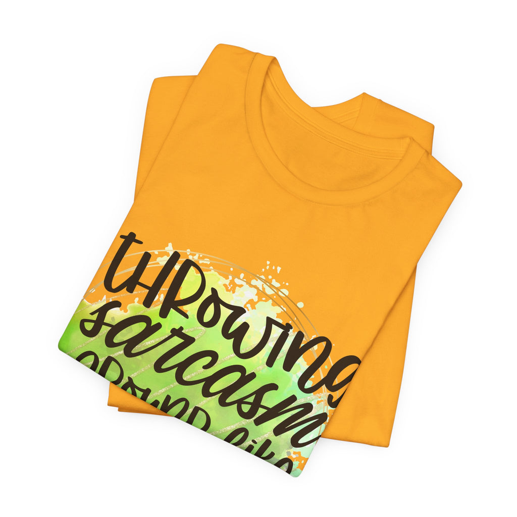 Folded yellow t-shirt with green and black text design on a white background